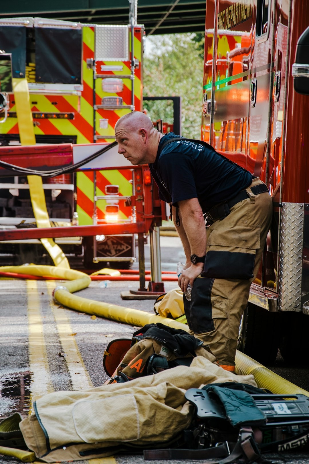 a fireman standing next to a fire hose
